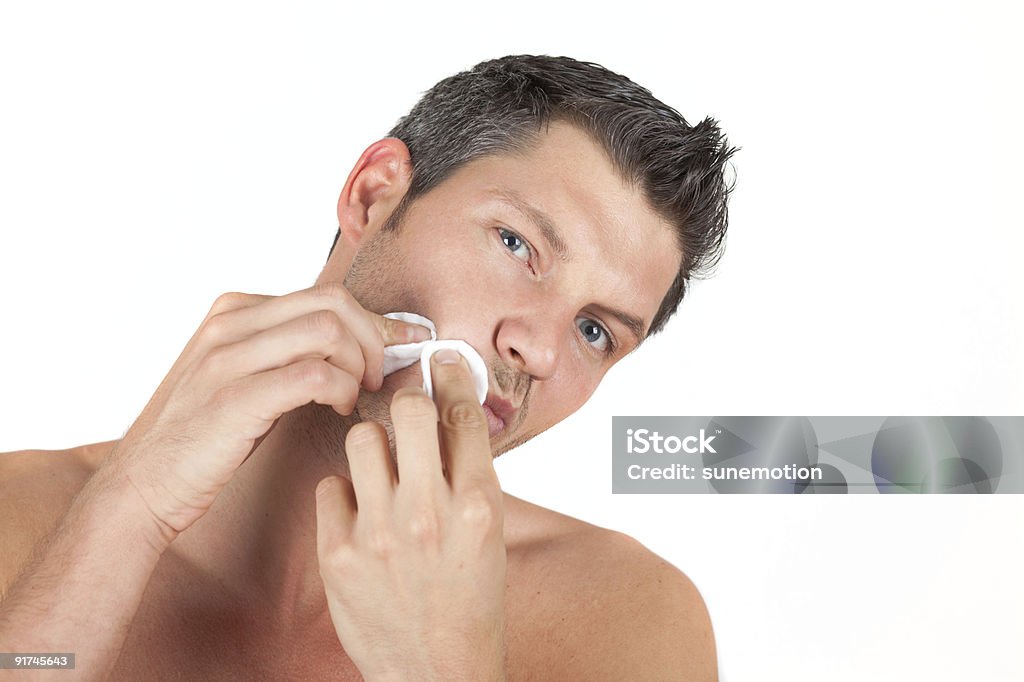 man using cotton pads to squeeze pimple  Adult Stock Photo