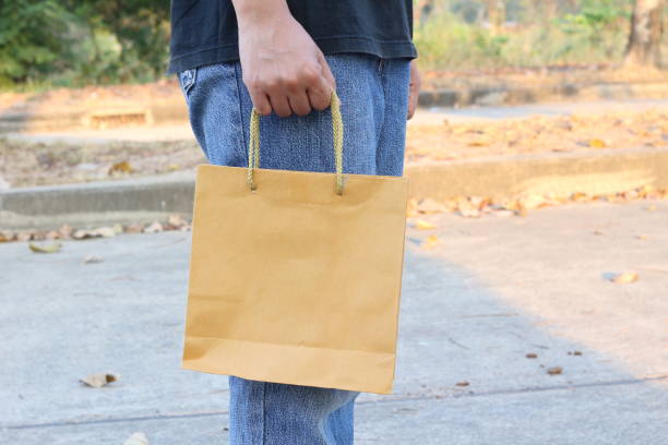 istock shopping with paper bag in hand 917461748