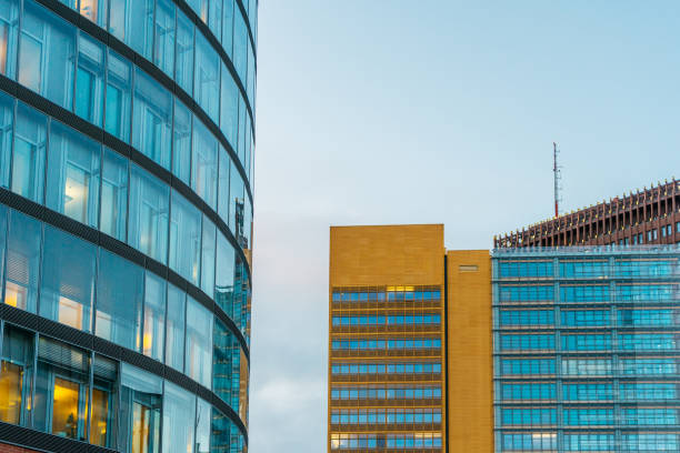 istock glass skyscraper next to an orange office building with beautiful modern facade 917461988
