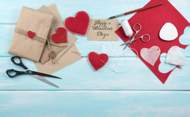 istock Workspace with tools for handmade and sewing felt hearts for Valentine's Day. 917462486