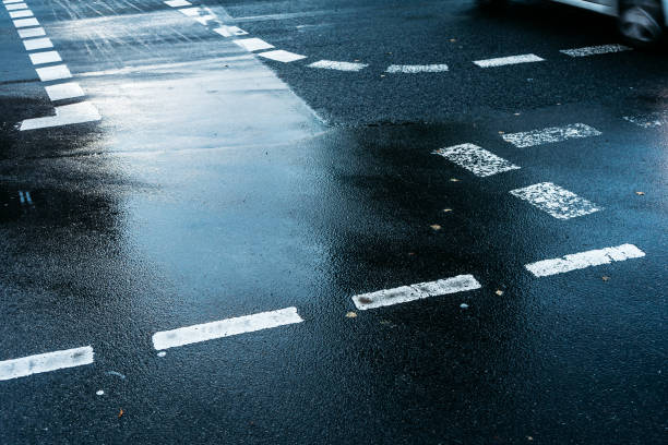 istock traffic road with white lines on a rainy day 917462750