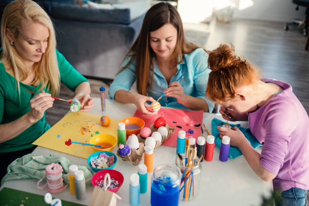 istock Mother and daughters crafting Easter decorations at home. 917468722