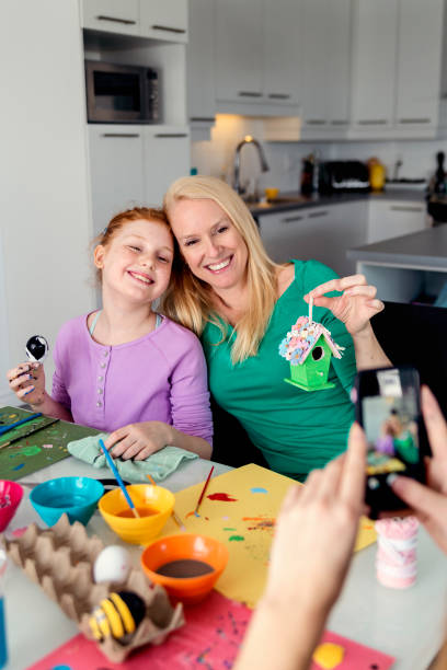 istock Mother and daughters crafting Easter decorations at home. 917468746