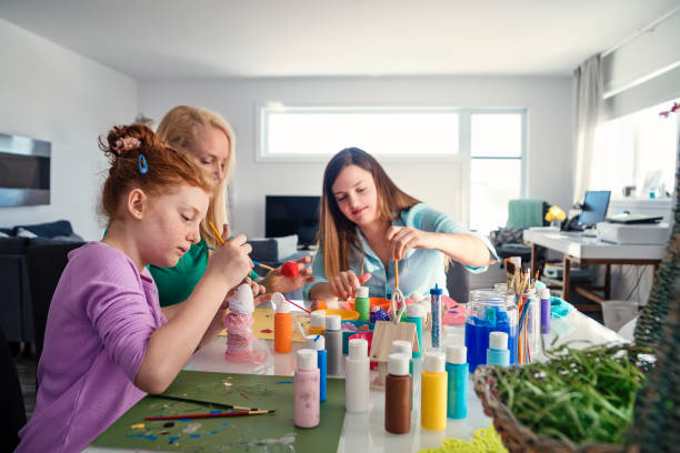 istock Mother and daughters crafting Easter decorations at home. 917468804