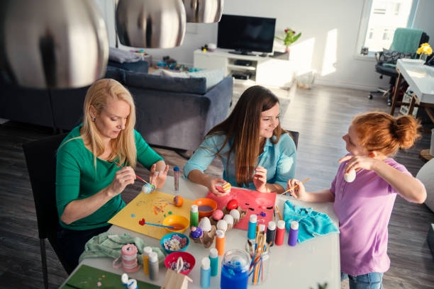 istock Mother and daughters crafting Easter decorations at home. 917470968