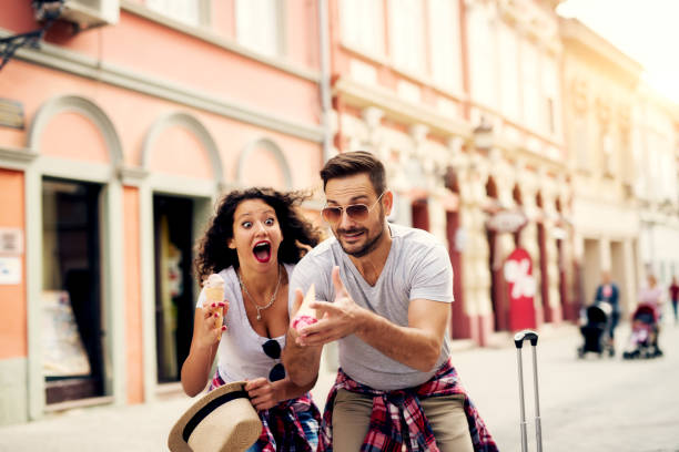 Awesome moment of dropping ice cream from man's hands to floor. Couple's impression while looking at dropped ice cream.