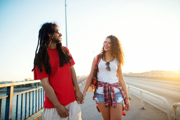 istock Portrait of a couple holding hands while walking on the bridge. 917471098