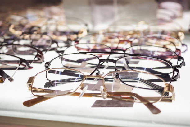 Eye glasses on window display shelves in optics store
