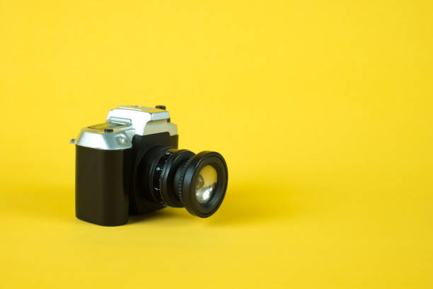 istock Mini camera toy on yellow background, copy space for add text. 917471838