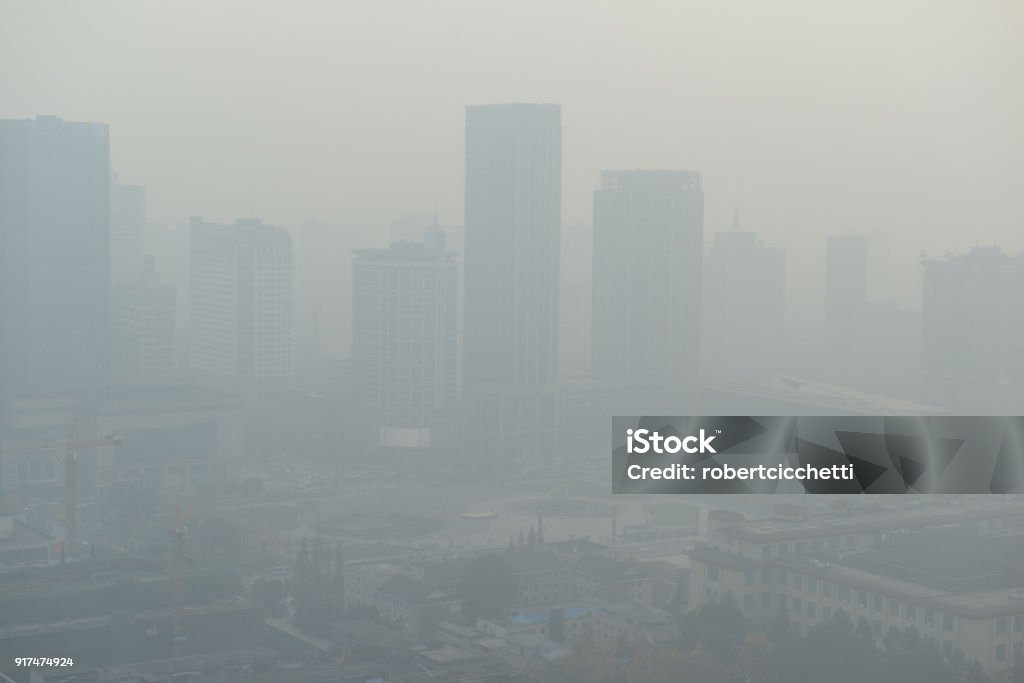 Large metropolitan city with terrible air pollution and smog, a contributor to health problems and potentially linked to global warming and climate change due in part to burning of fossil fuels Air Pollution Stock Photo