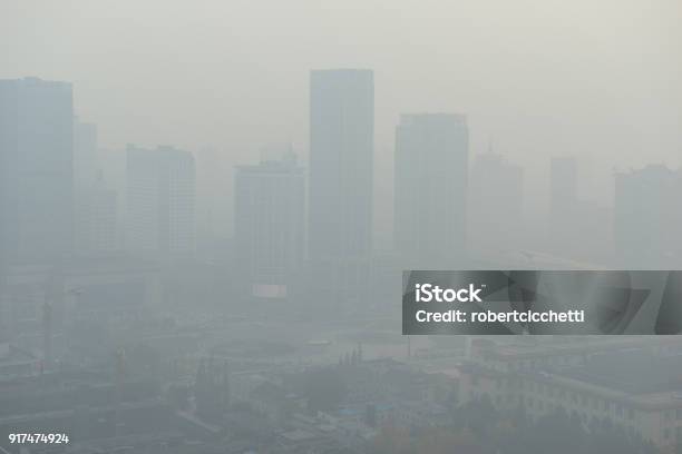 Large Metropolitan City With Terrible Air Pollution And Smog A Contributor To Health Problems And Potentially Linked To Global Warming And Climate Change Due In Part To Burning Of Fossil Fuels Stock Photo - Download Image Now