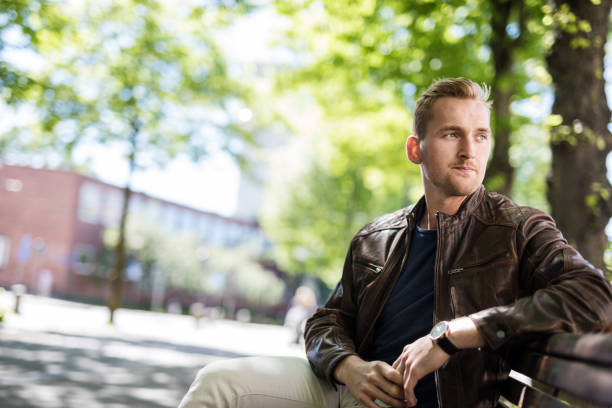 istock Pensive man sitting outdoors 917475690