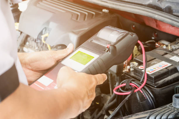 istock mechanic use voltmeter checking voltage of car battery in car service centre 917481808