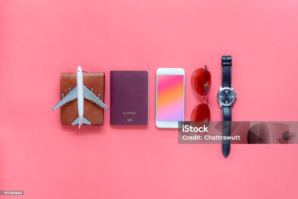 Flat lay image of accessory clothing man or women to plan travel in holiday background concept.Mobile phone & passport with many item in vacation season.Table top view several object on pink paper. Travel Stock Photo