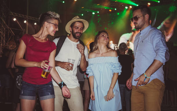 istock People dancing on festival and drinking beer 917487688