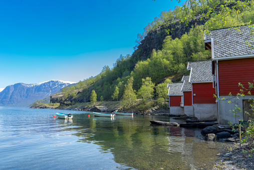 A row of red small house with small boats at Flam, Norway