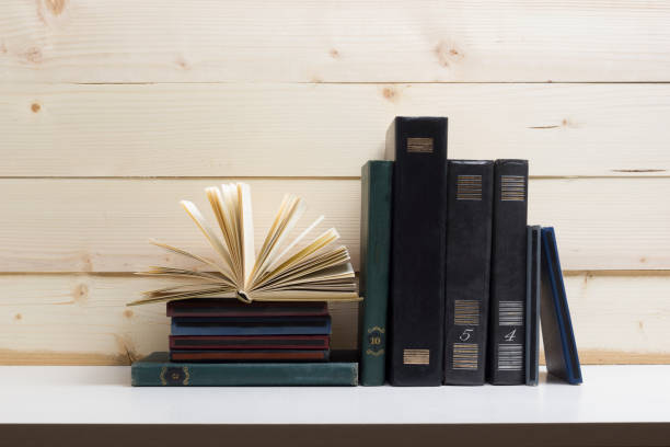 istock Open book, hardback books on wooden table. Back to school. Copy space 917499446