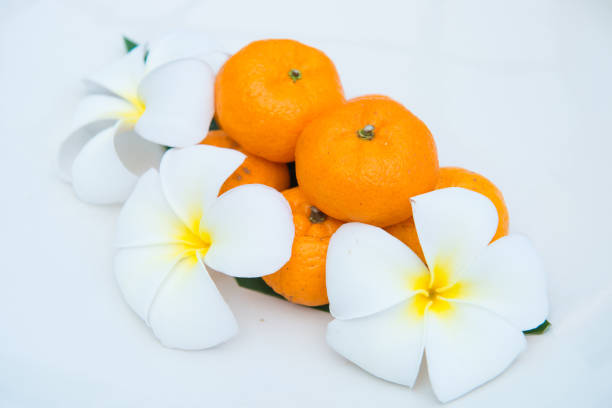 istock Fresh mandarin oranges on white dish decorate with flower 917502434