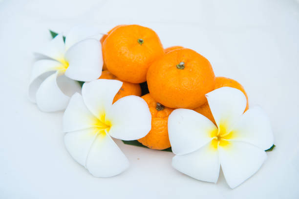 istock Fresh mandarin oranges on white dish decorate with flower 917502472
