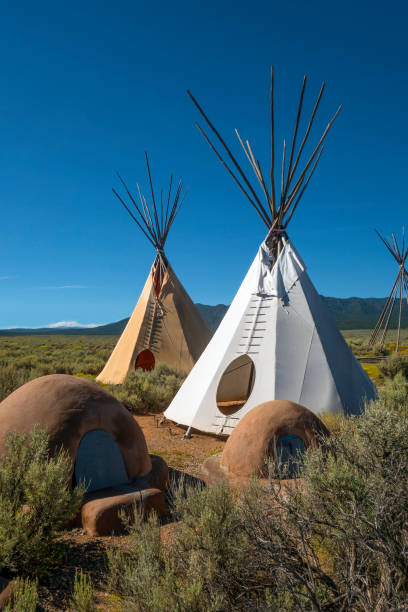Tipis and ovens Adobe ovens outside tipis on the Taos Plateau. Northern New Mexico, American Southwest. adobe oven stock pictures, royalty-free photos & images