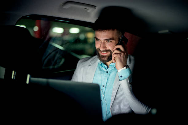 istock Businessman working talking sitting in a car at garage. 917502736