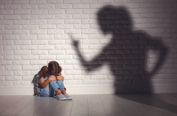domestic violence. angry mother scolds   frightened daughter domestic violence. angry mother scolds   frightened daughter sitting on floor punishment photos stock pictures, royalty-free photos & images