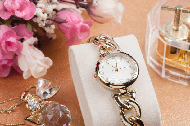 woman accessories, closeup shiny gold women wristwatch