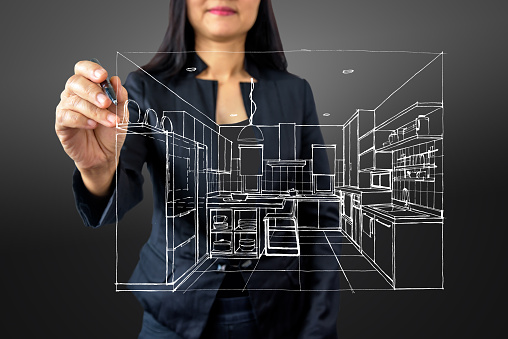 Businesswoman (Architect / Interior designer) drawing 3D Kitchen on modern futuristic virtual screen