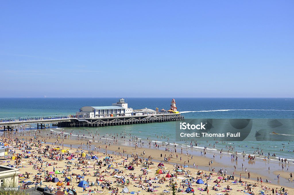 Bournemouth Pier Detail of Bournemouth Pier and crowded beach. Bournemouth - England Stock Photo