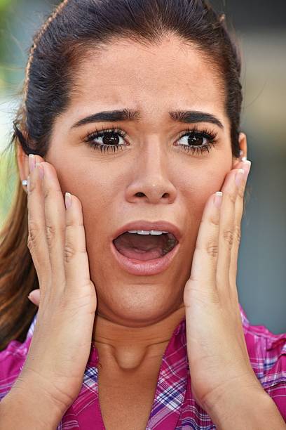 istock Startled Young Woman Wearing Pink Shirt 917519364