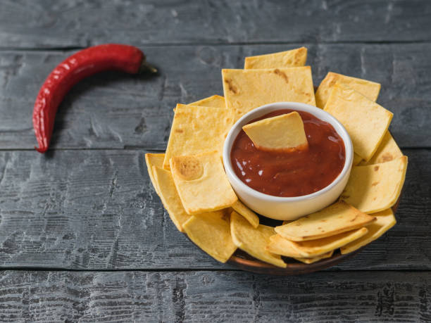 istock The Mexican tortilla chips with cheese and chili peppers on a rustic table. 917522786
