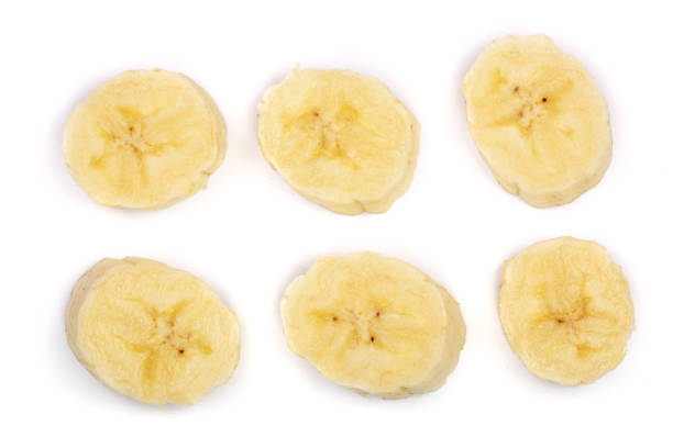 istock Banana slices isolated on a white background. Flat lay, top view 917525256