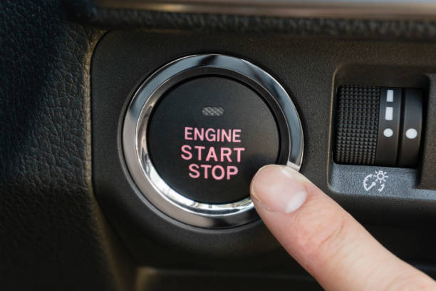 istock Pushing the engine start stop button of a car 917525388