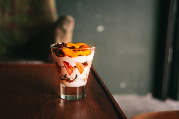 istock Yogurt with granola parfait on wooden table 917525584