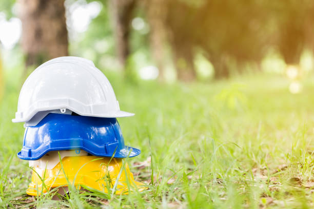 istock Engineer safety helmet on green grass 917528618