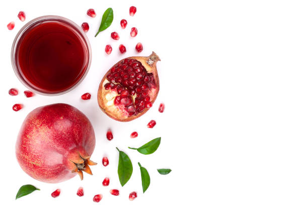 istock pomegranate juice with fresh pomegranate fruits isolated on white background with copy space for your text. Top view 917529110