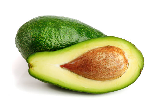 istock avocado and half isolated on white background close-up 917529224