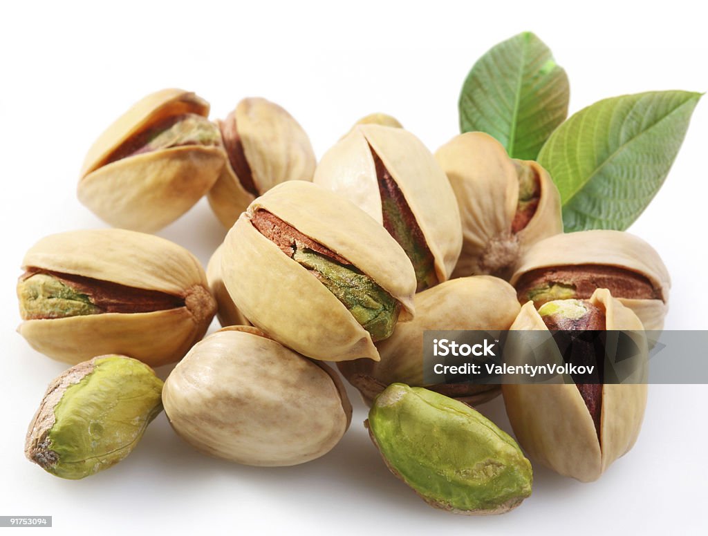 Close up of pistachios against a white background Pistachios on a white background Color Image Stock Photo