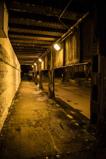 istock Dark city alley industrial train bridge underpass at night. 917532624