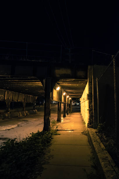 istock Dark city alley industrial train bridge underpass at night. 917532722