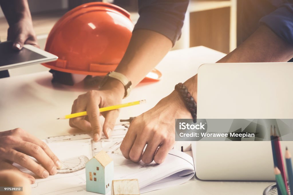 Two Architect man working with compasses and blueprints for architectural plan,engineer sketching a construction project concept. Architecture Stock Photo