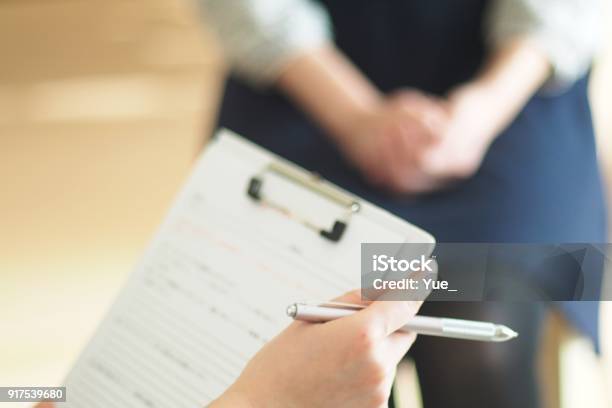 Young Womans Aromatherapist Counseling Patient Stock Photo - Download Image Now - Advice, Medical Exam, Form Filling