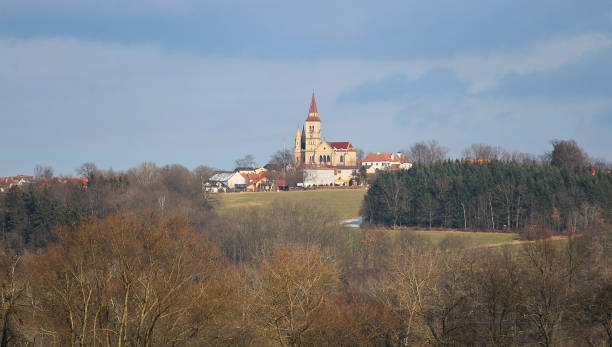 istock Church in village Hosin with dramatic sky, Czech landscape 917543206