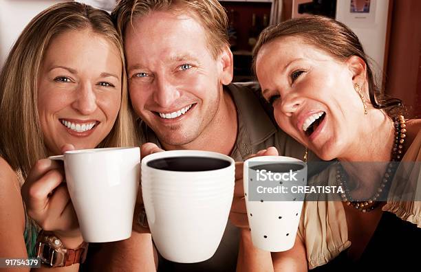 Three Friends Having Fun While Toasting With Coffee Stock Photo - Download Image Now