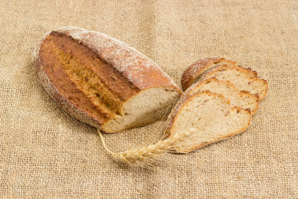 istock Brown bread with whole sprouted wheat grains, wheat ear 917547506