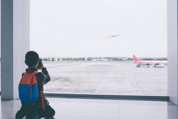 istock Young boy photographing at airport 917549700