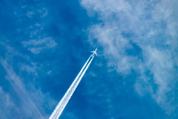 An aircraft in the sky seen from the ground.