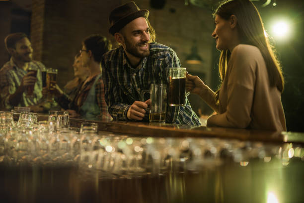 istock Happy couple communicating at bar counter during the night out. 917549828