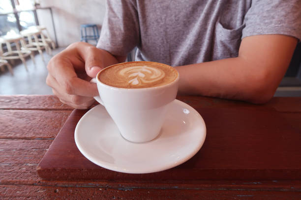 istock Man drinking hot coffee in coffee shop. 917550810