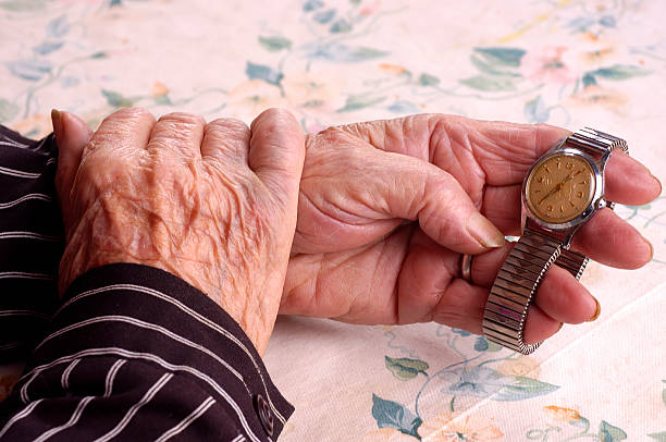 istock Elderly women holding her wrist watch 91755356